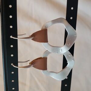 Earrings Matte silver tone and faux leather.